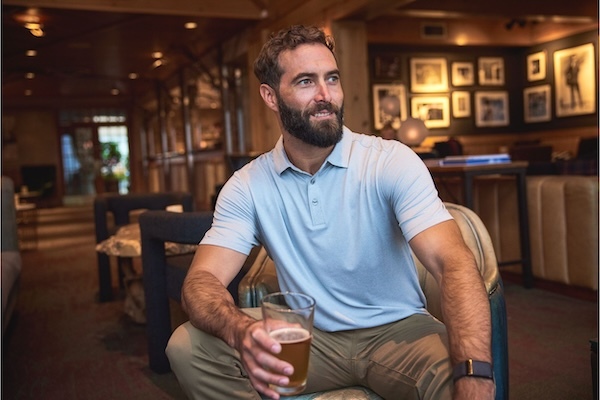 Man wearing a light blue Cutter & Buck Coastline polo shirt