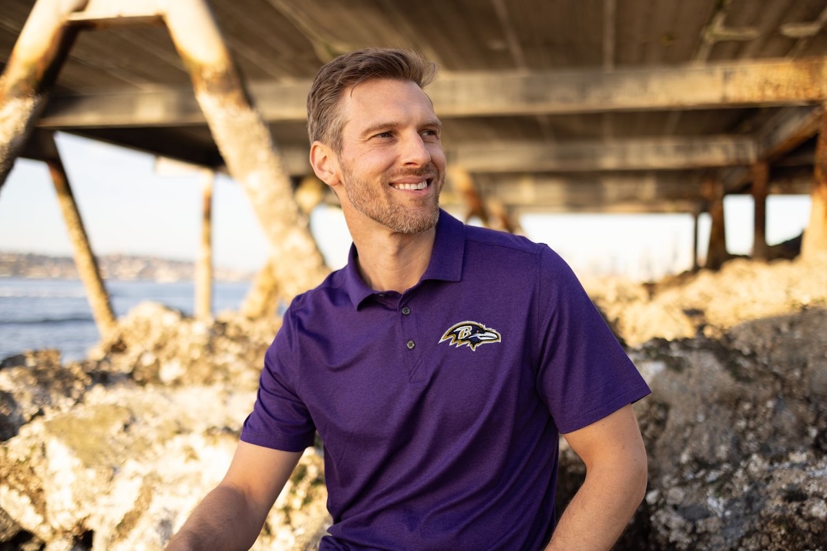Man wearing Coastline Epic Comfort Baltimore Ravens Polo