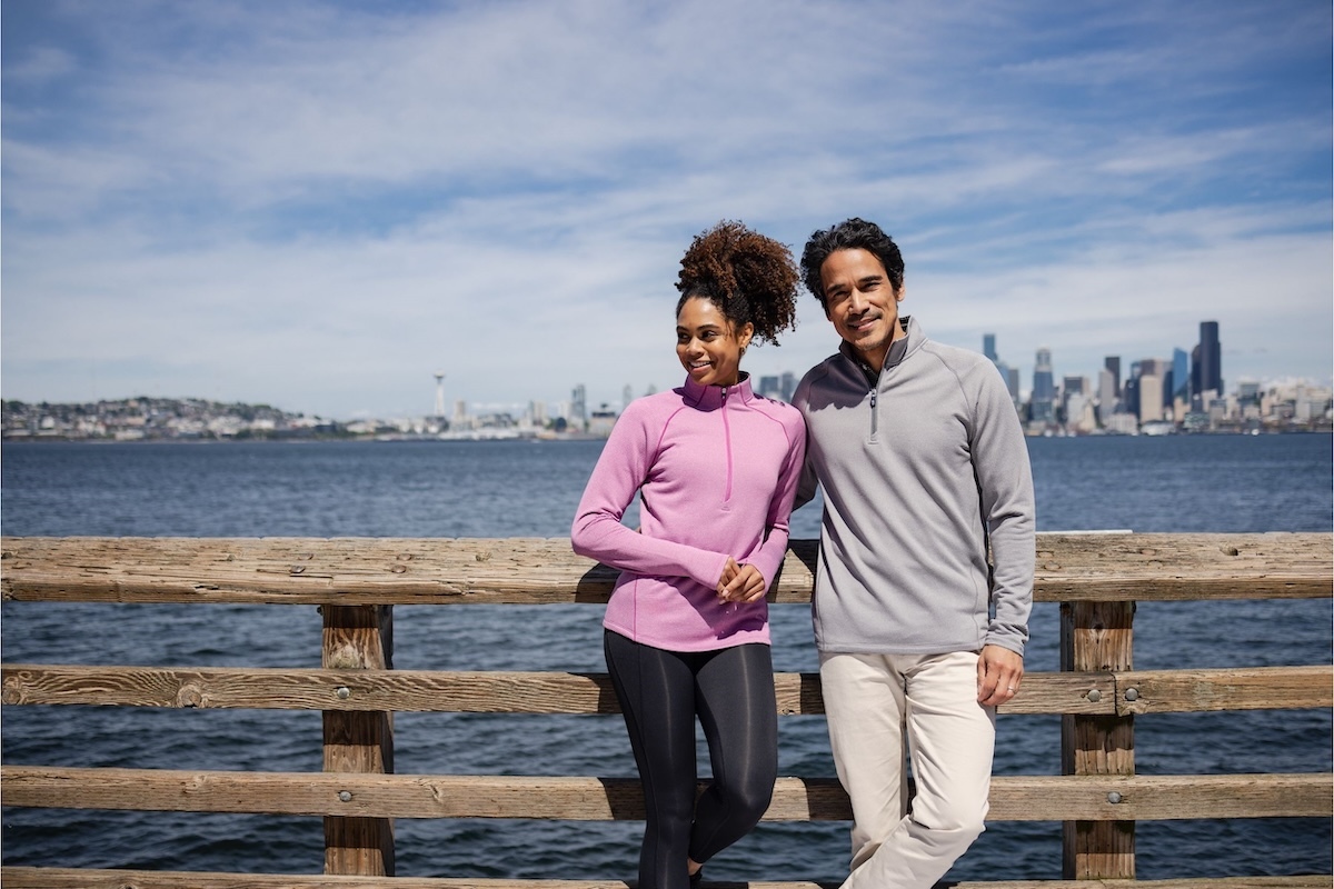 Man & woman wearing Peshastin performance fleece pullovers on a Seattle pier