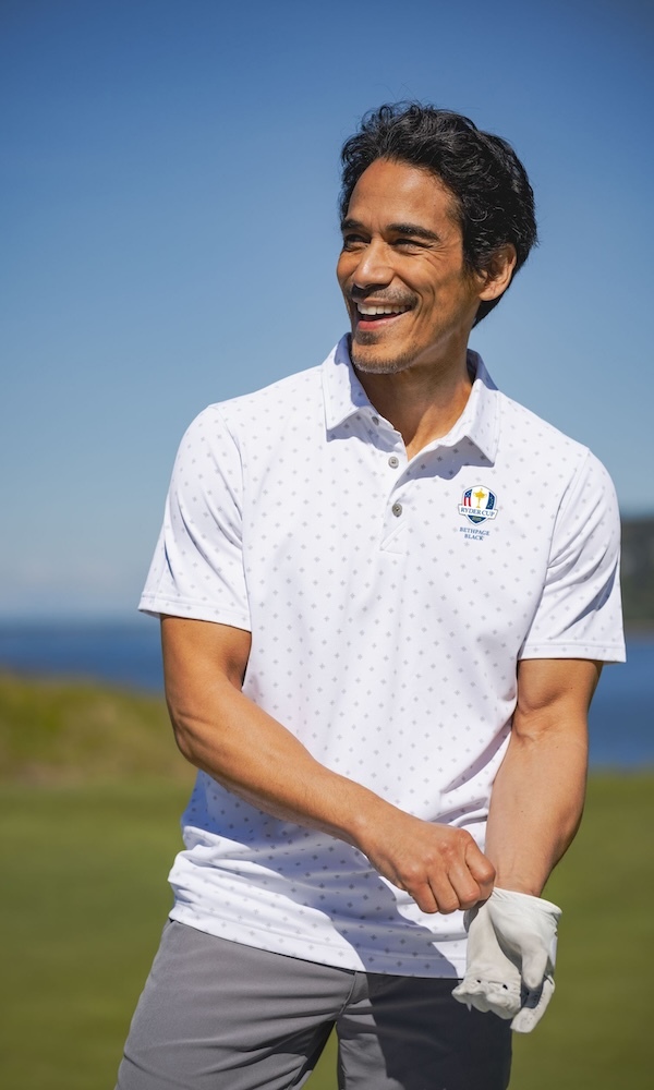 Male golfer wearing a white Cutter & buck Ryder Cup Virtue title print polo