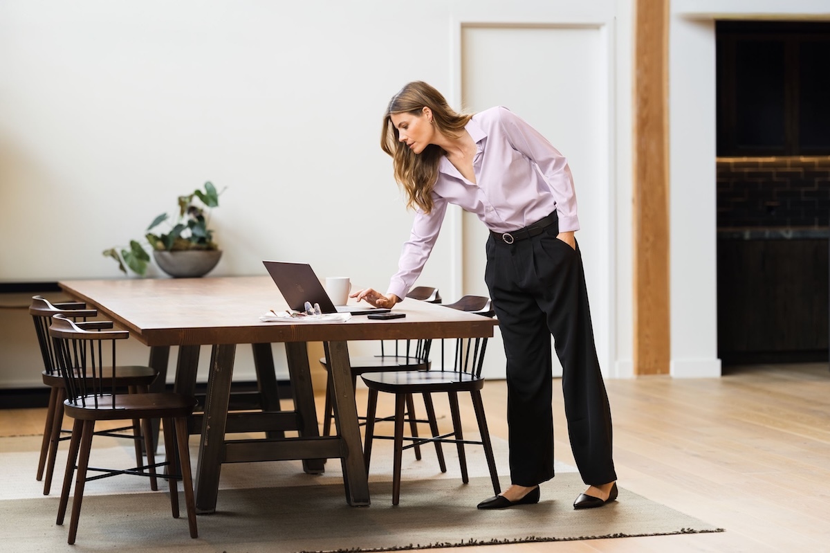 Woman wearing Cutter & Buck Skyline End on End dress shirt while working